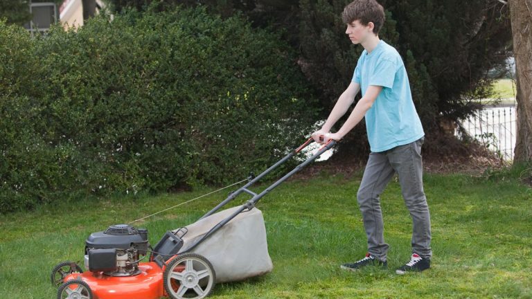 Boy mowing lawn