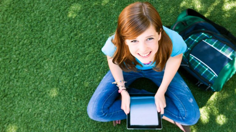 Girl sitting down with tablet