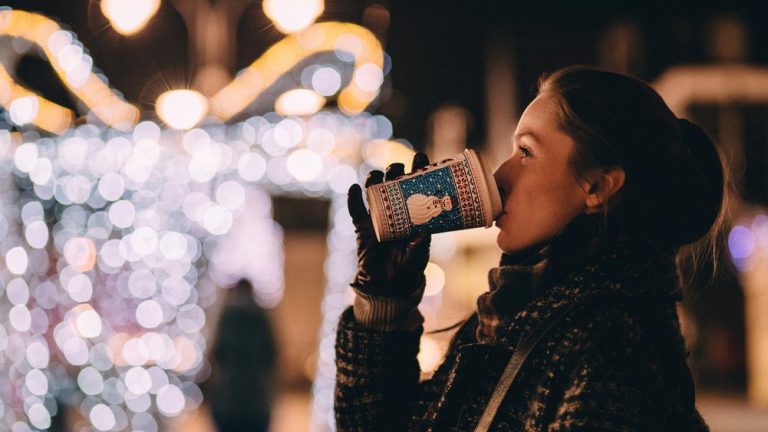 woman drinking coffee with snowman on the cup