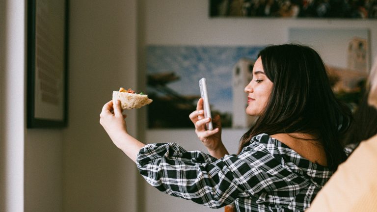 woman taking photos of food for instagram