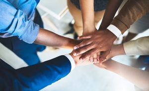 Cropped shot of a group of businesspeople piling their hands on top of each other